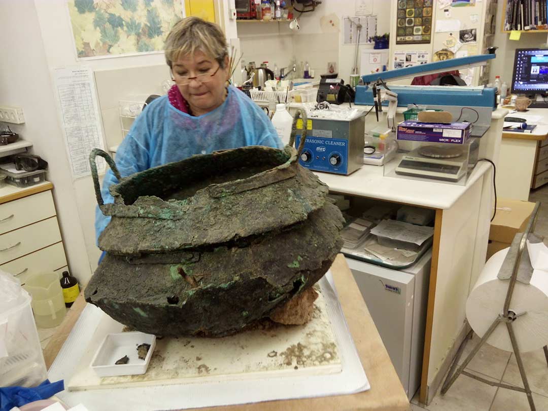 Restoring a bronze cauldron found during excavation of the temple at Tel Lachish
