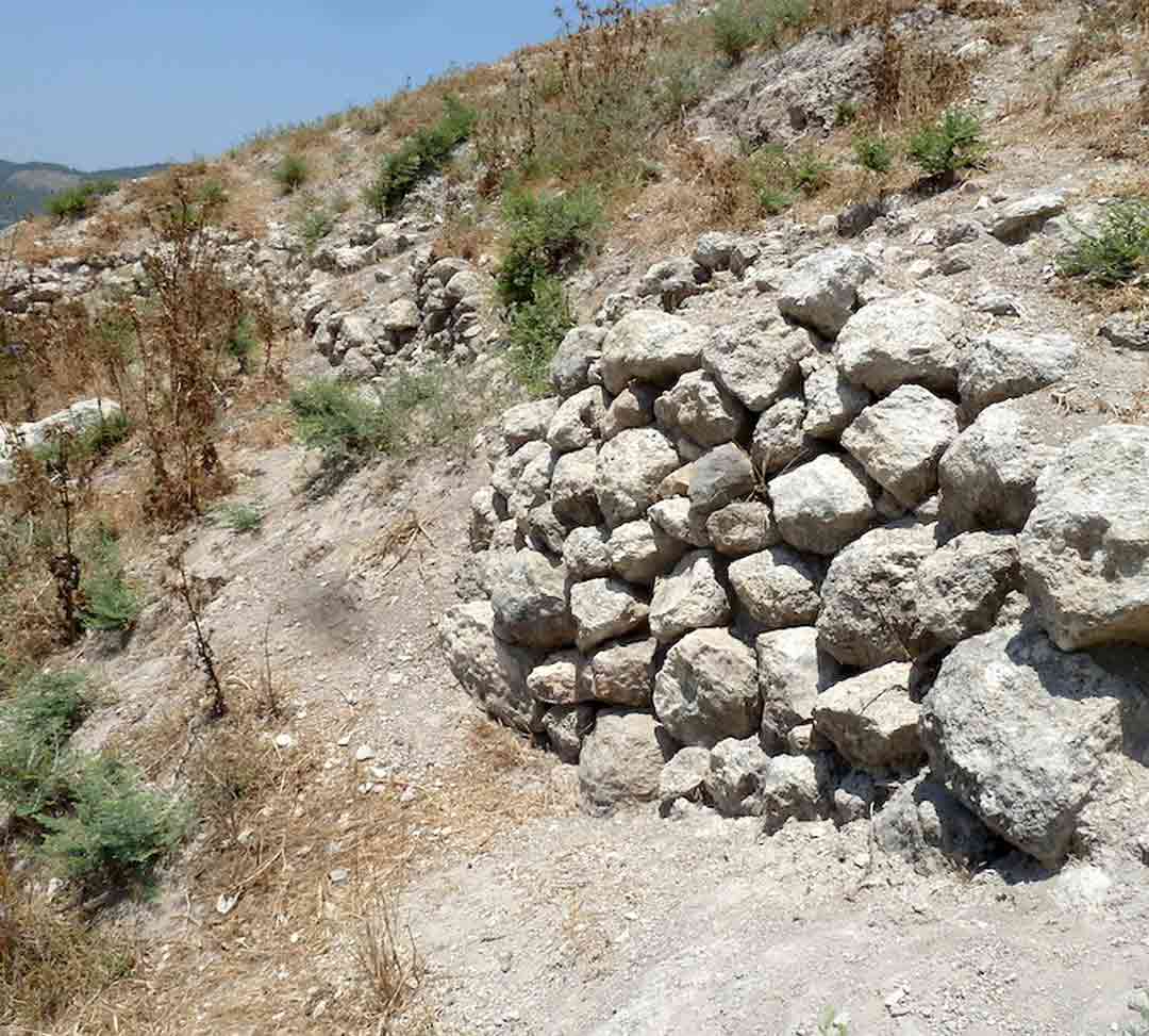 A wall with sherds along its base