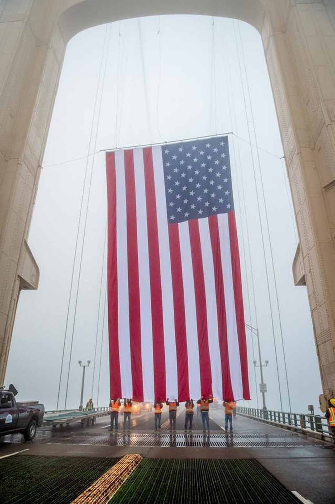 Giant American Flag suspended from the Mackinac Bridge in Michigan
