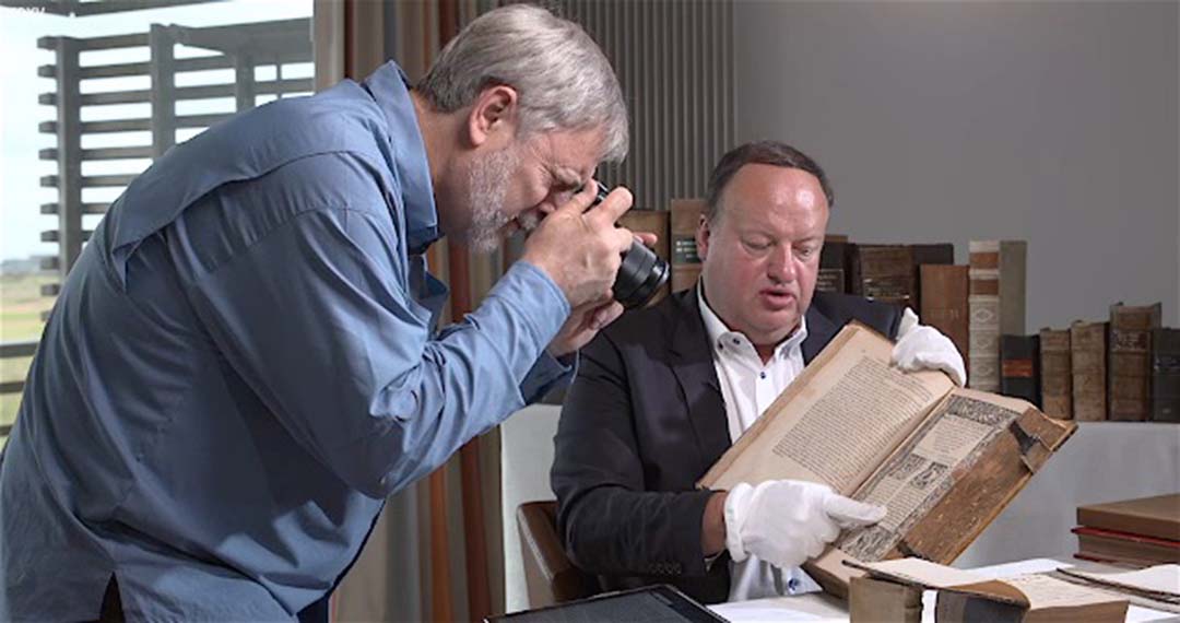 Tim Mahoney photographing a copy of Erasmus's New Testament